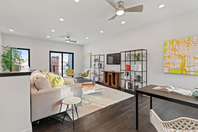 living room with ceiling fan and dark wood-type flooring