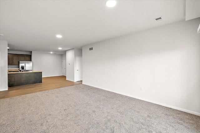 unfurnished living room featuring carpet