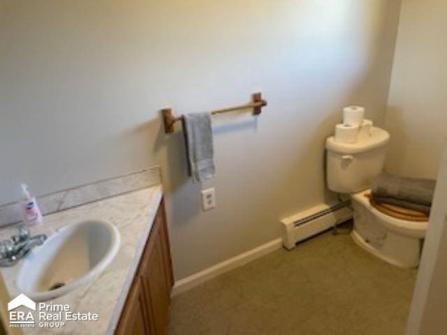 bathroom featuring vanity, a baseboard radiator, and toilet