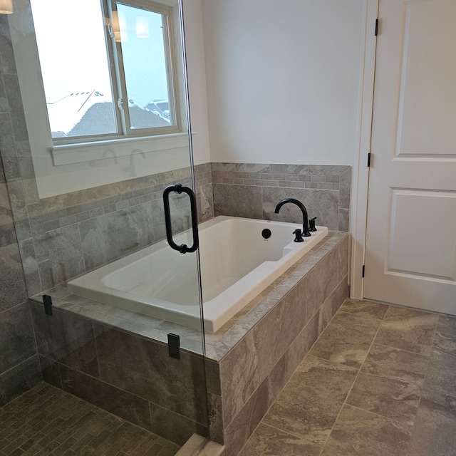 bathroom featuring tiled bath