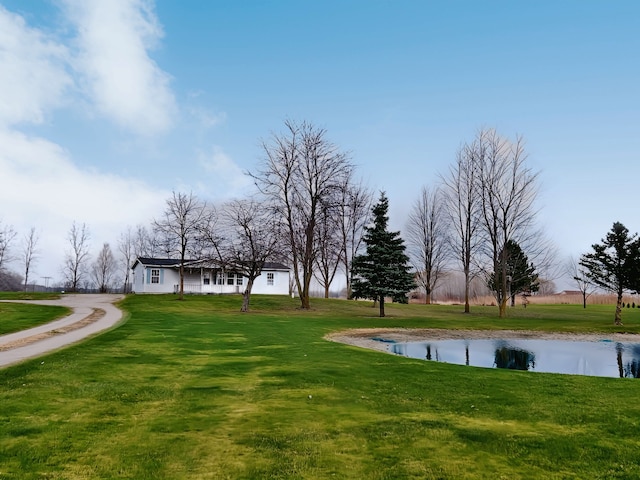 surrounding community with a lawn and a water view