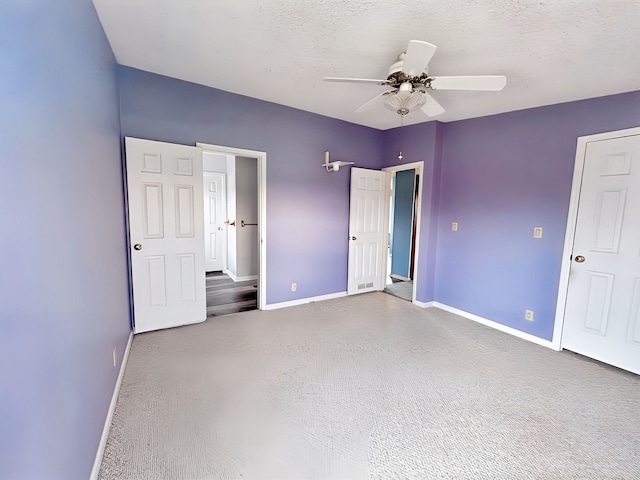 unfurnished bedroom featuring ceiling fan and a textured ceiling