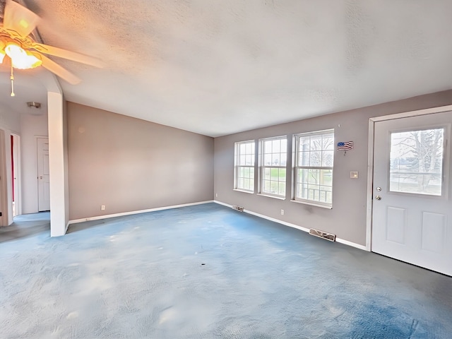 entryway featuring a textured ceiling, a wealth of natural light, and ceiling fan