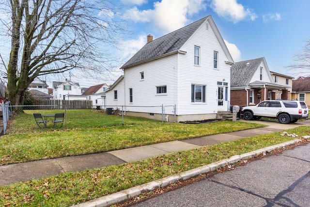 view of side of home featuring a lawn