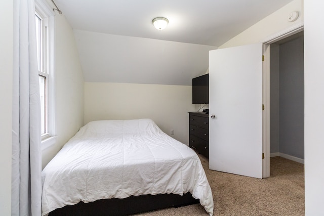 bedroom featuring carpet and lofted ceiling