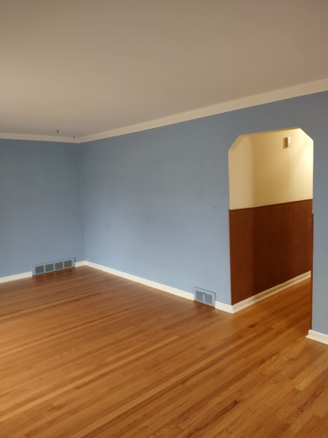 unfurnished room with light hardwood / wood-style floors and ornamental molding