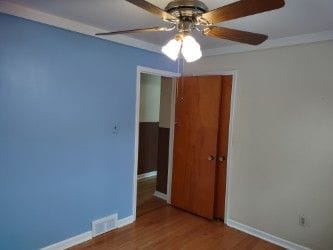 spare room featuring ceiling fan, crown molding, and hardwood / wood-style flooring