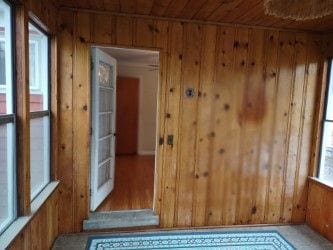 interior space featuring wood walls and wooden ceiling