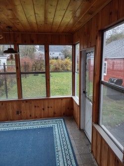 unfurnished sunroom with a healthy amount of sunlight and wood ceiling