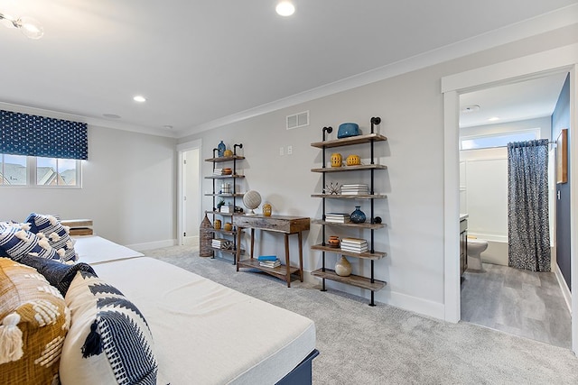 bedroom with ensuite bath, light colored carpet, crown molding, and multiple windows