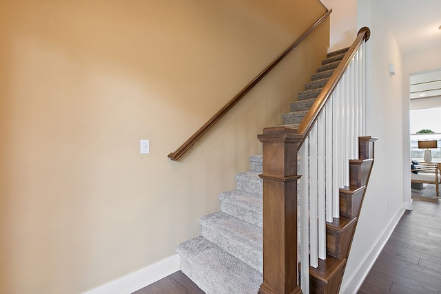 stairs featuring hardwood / wood-style flooring