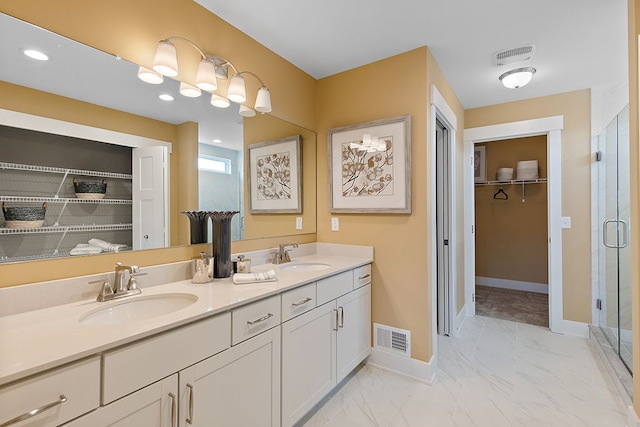 bathroom with vanity and a shower with door