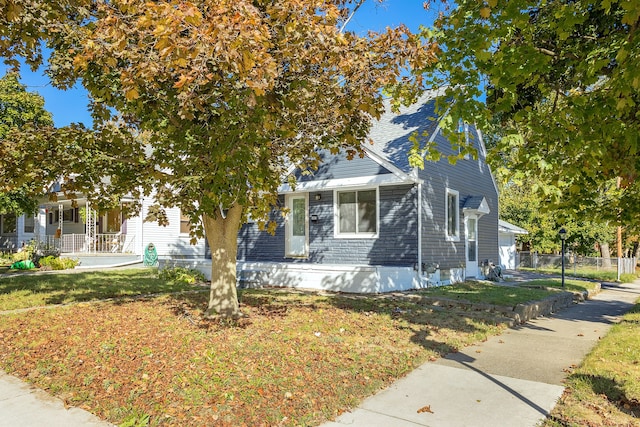 view of property hidden behind natural elements with a front lawn