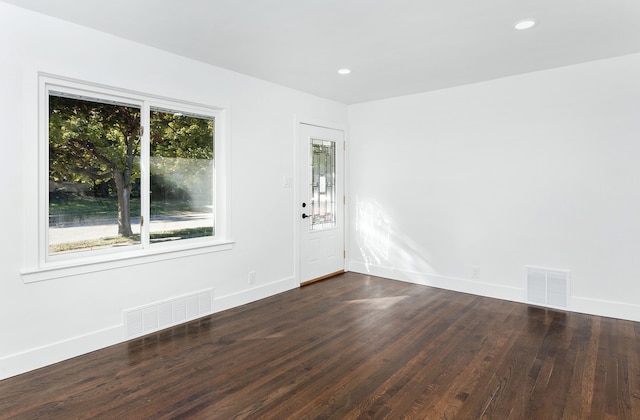 unfurnished room featuring dark wood-type flooring