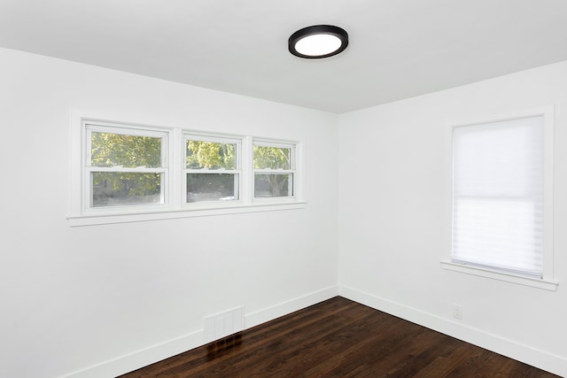 empty room featuring dark wood-type flooring