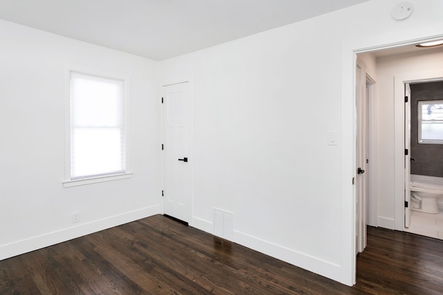 spare room with dark hardwood / wood-style floors