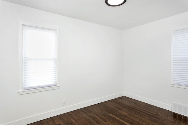 spare room featuring wood-type flooring