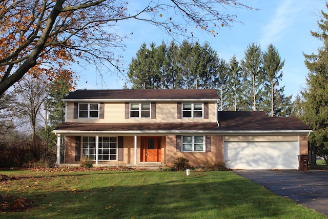 view of front of home featuring a garage and a front lawn