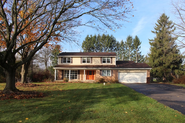 view of front of home with a front yard and a garage