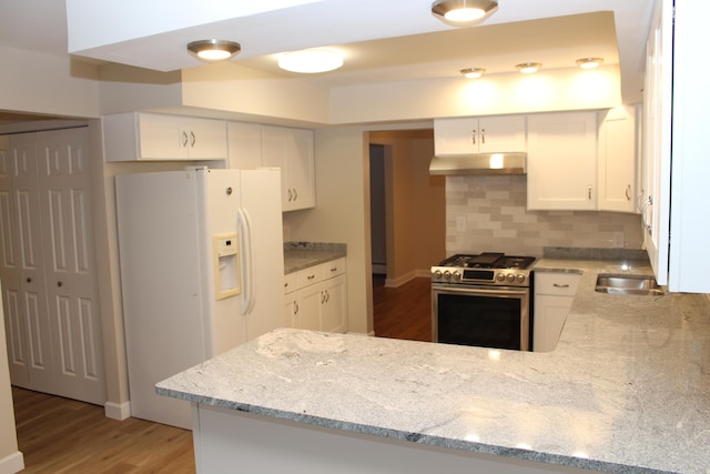 kitchen featuring kitchen peninsula, white cabinetry, hardwood / wood-style floors, and stainless steel stove