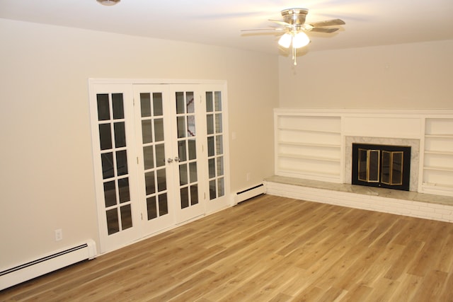 unfurnished living room with a fireplace, wood-type flooring, and a baseboard radiator