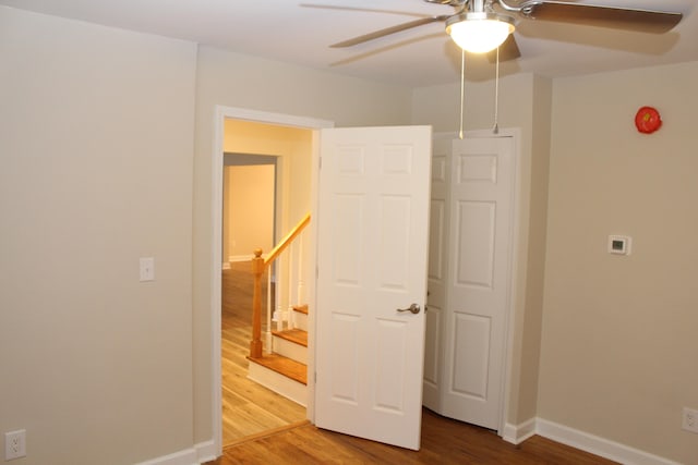 unfurnished bedroom featuring hardwood / wood-style floors and ceiling fan