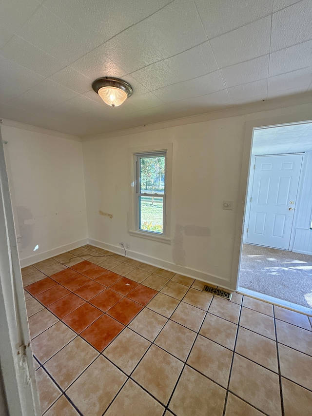 unfurnished room with light tile patterned floors