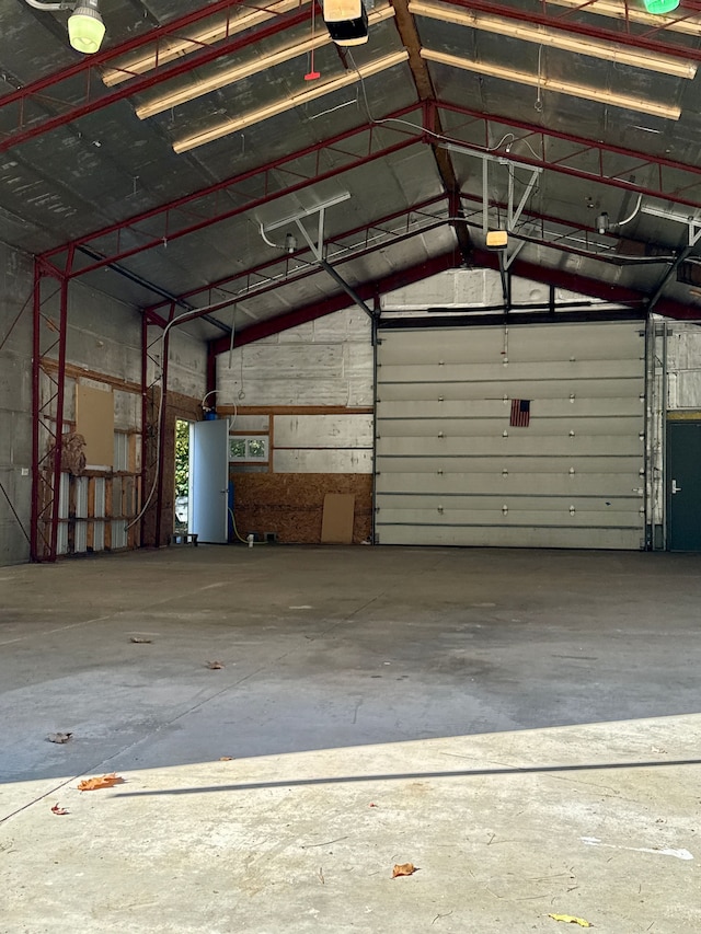 garage with a garage door opener and water heater