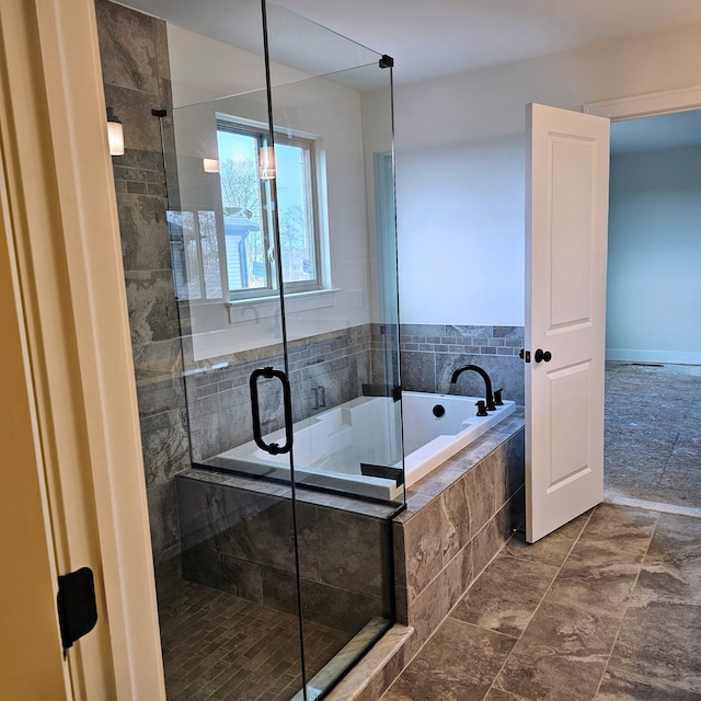 bathroom featuring shower with separate bathtub