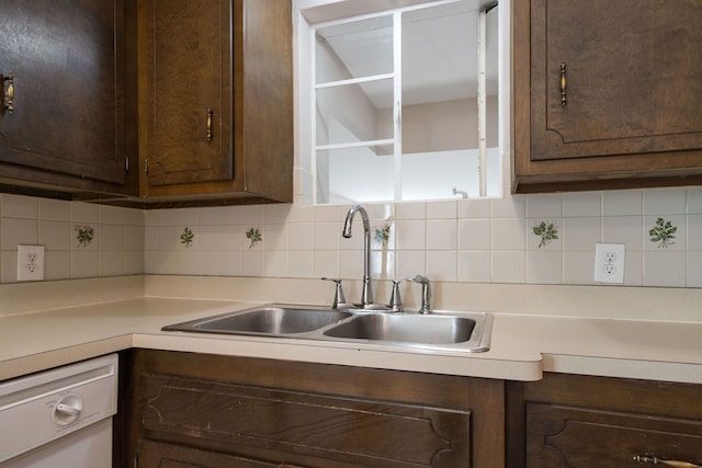 kitchen featuring tasteful backsplash, dishwasher, dark brown cabinets, and sink