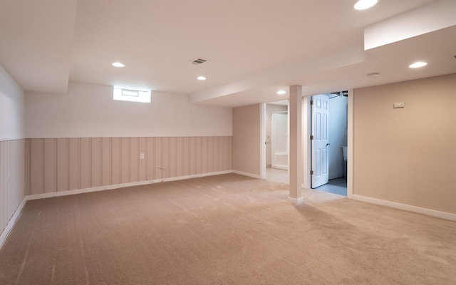 basement featuring light carpet