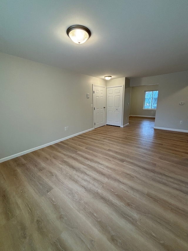 empty room with light hardwood / wood-style flooring