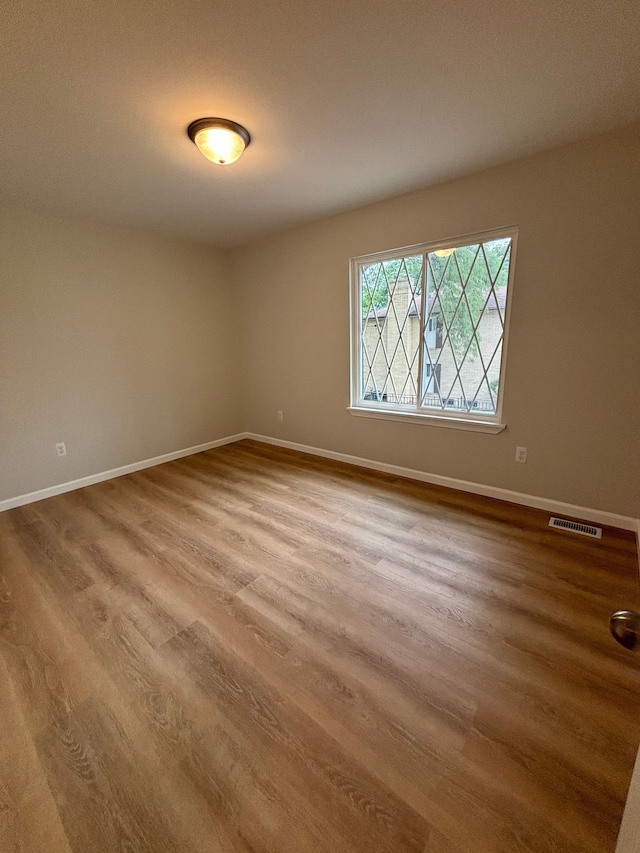 empty room featuring wood-type flooring