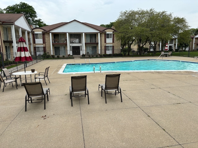 view of swimming pool with a patio