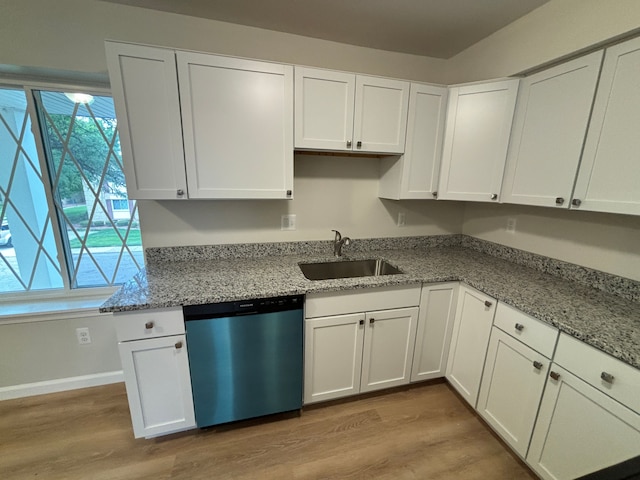 kitchen with white cabinets, sink, stainless steel dishwasher, light hardwood / wood-style floors, and light stone counters