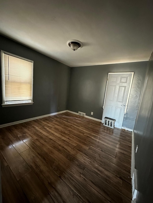 unfurnished room featuring dark hardwood / wood-style floors