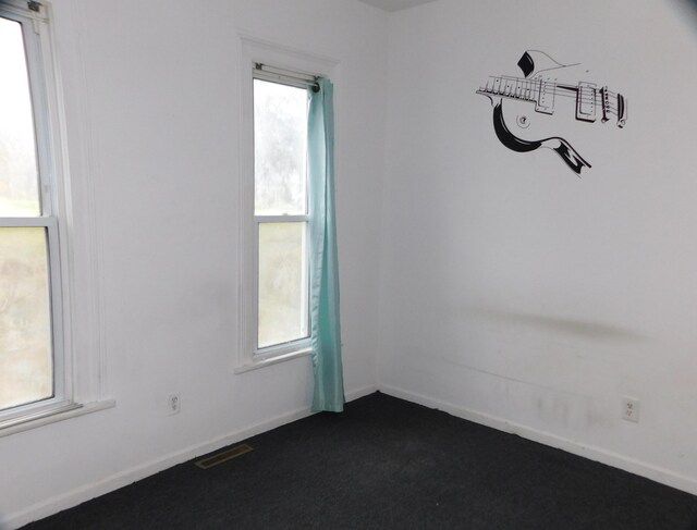 138 E Euclid Ave, Jackson, MI 49203 - unfurnished room with dark carpet and baseboards