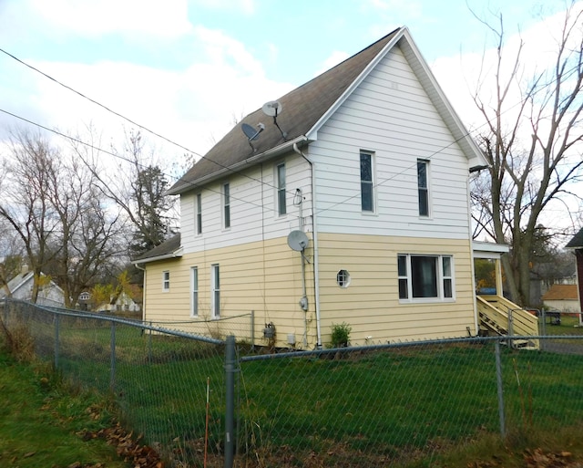 rear view of property with a lawn