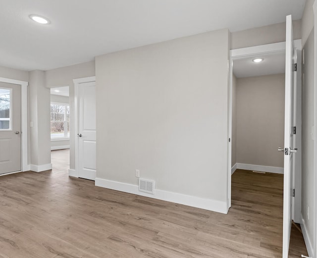spare room featuring light hardwood / wood-style floors