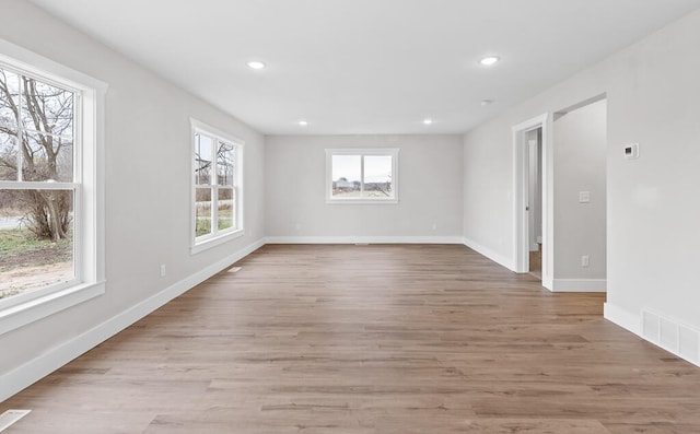unfurnished room featuring plenty of natural light and light hardwood / wood-style flooring