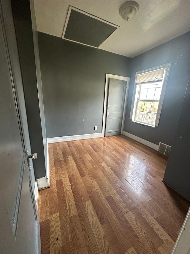 empty room with light hardwood / wood-style flooring