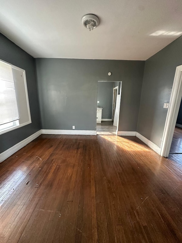 unfurnished room featuring dark wood-type flooring