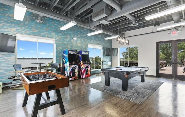 recreation room featuring french doors, hardwood / wood-style floors, a high ceiling, and billiards