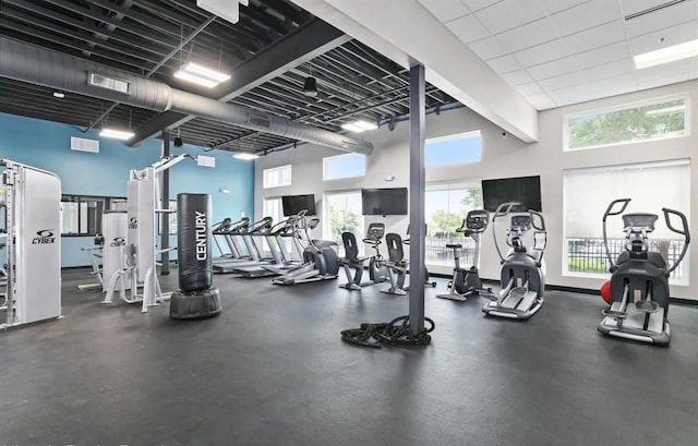 gym with a towering ceiling