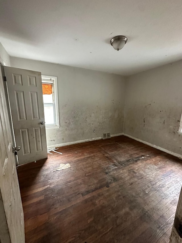 empty room with dark hardwood / wood-style floors