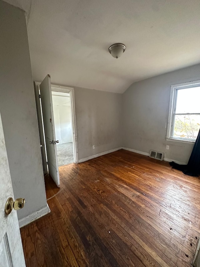 bonus room featuring dark hardwood / wood-style floors and lofted ceiling