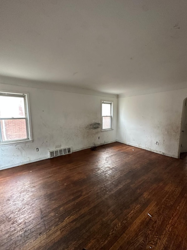 spare room with dark hardwood / wood-style flooring