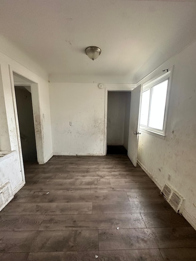 unfurnished room featuring dark hardwood / wood-style flooring