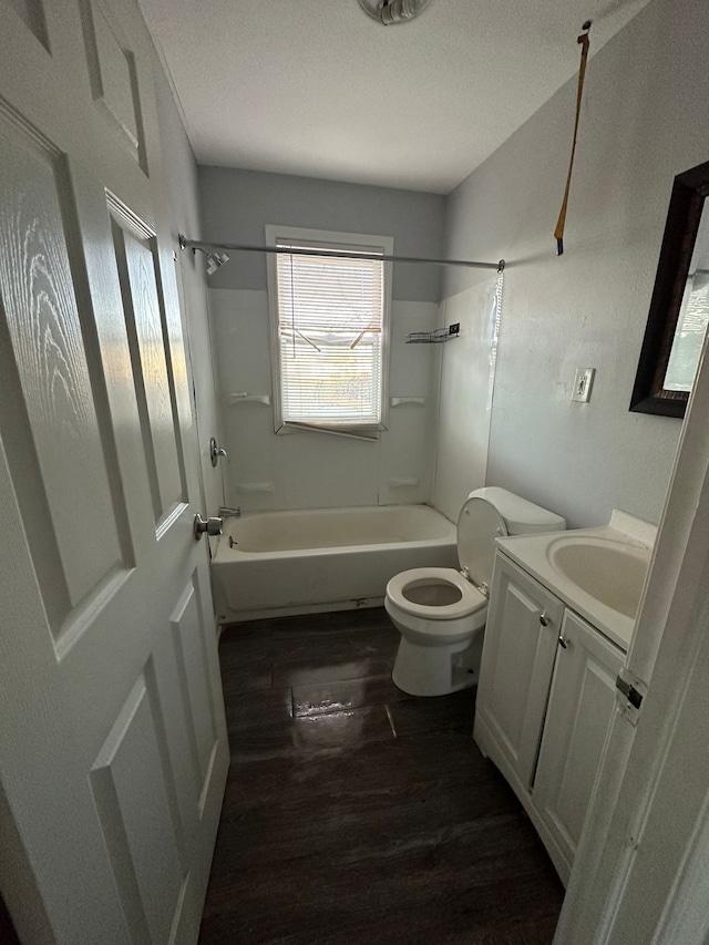 full bathroom featuring wood-type flooring,  shower combination, a textured ceiling, and toilet