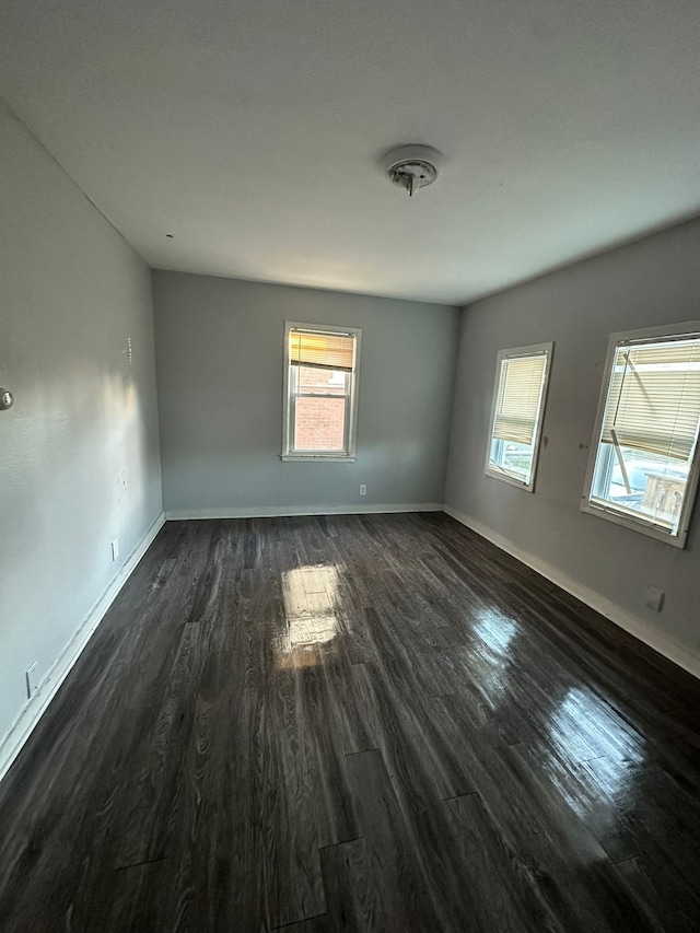 spare room with dark hardwood / wood-style floors